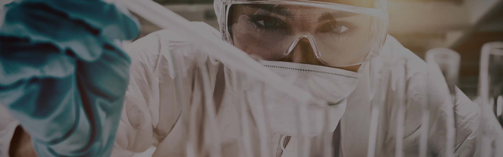 Close up of woman in a medical mask and protective glasses