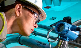 Woman looking at Rosemount instrument