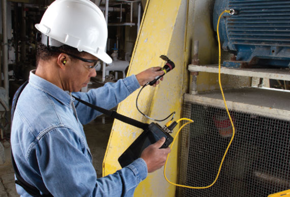Technician using AMS Machinery Health Analyzer to check equipment, industrial reliability solutions, asset reliability solutions, asset reliability services